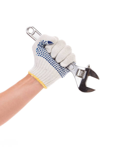 istock Hand in gloves holds an adjustable wrench. 1227556345
