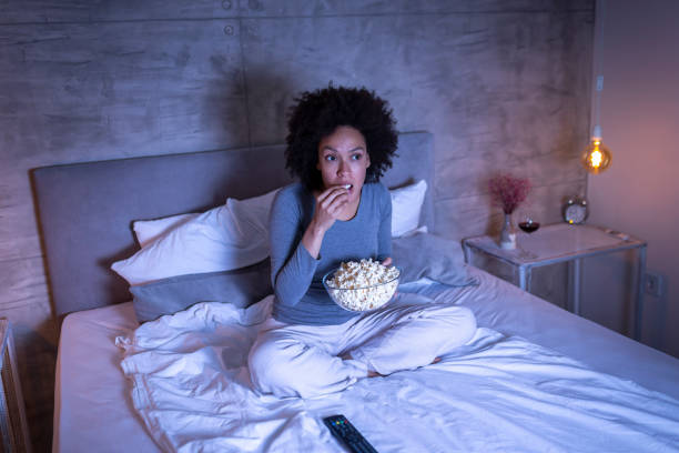 istock Woman watching movie in bed 1227557285