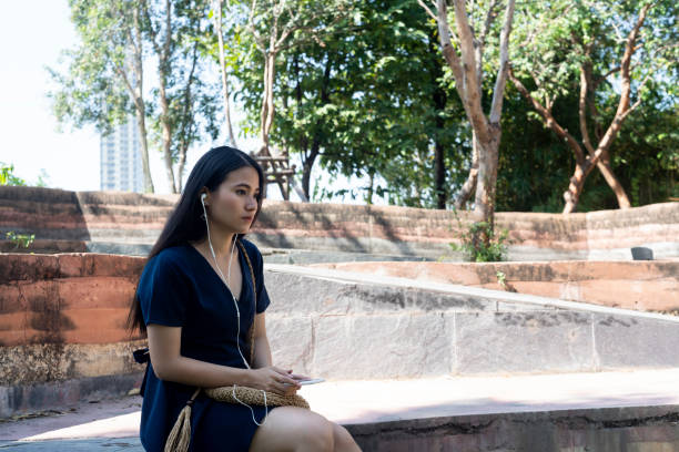 istock Sad woman in the park. 1227557508