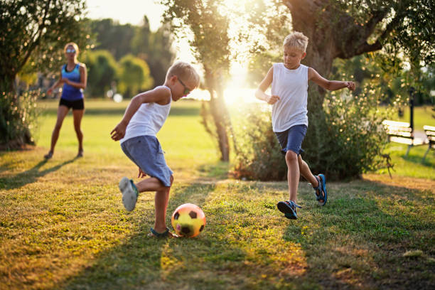 istock Kids playing soccer in the park. 1227557532
