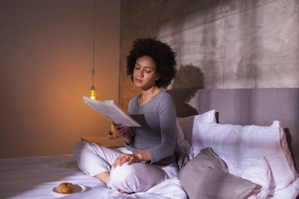 istock Woman reading newspapers and having breakfast in bed 1227558287