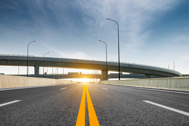 istock Dusk colored clouds in the background, highway overpass curved approach bridge 1227558319