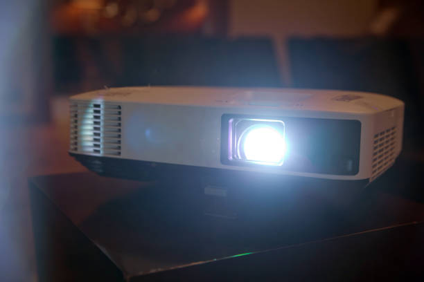 istock LCD video projector at business conference or lecture in office with copy space. projector on ceiling indoors. 1227560161