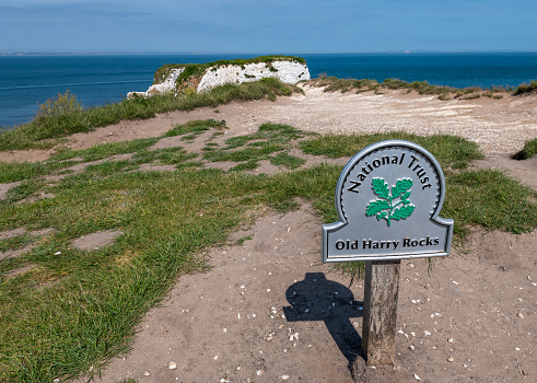 Studland, Dorset, UK. Wednesday 27 May 2020. A National Trust Sign for Old Harry Rocks in Dorset by the cliff edge.