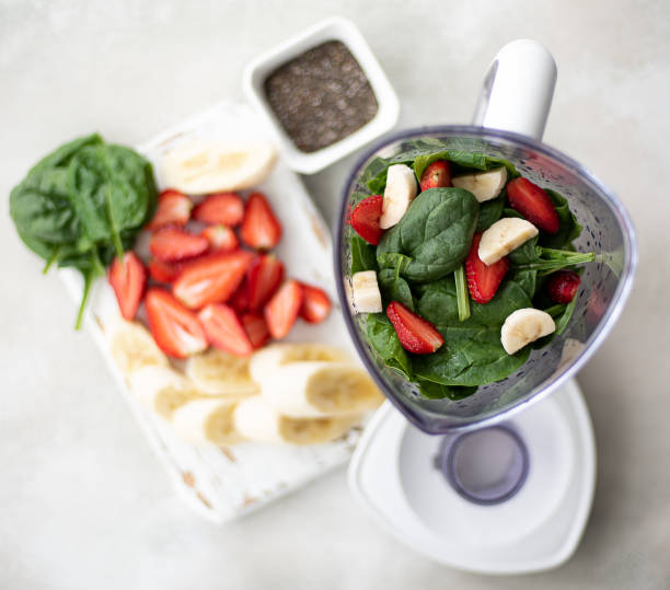 istock spinach, strawberry and banana smoothie ingredients in a blender 1227562889