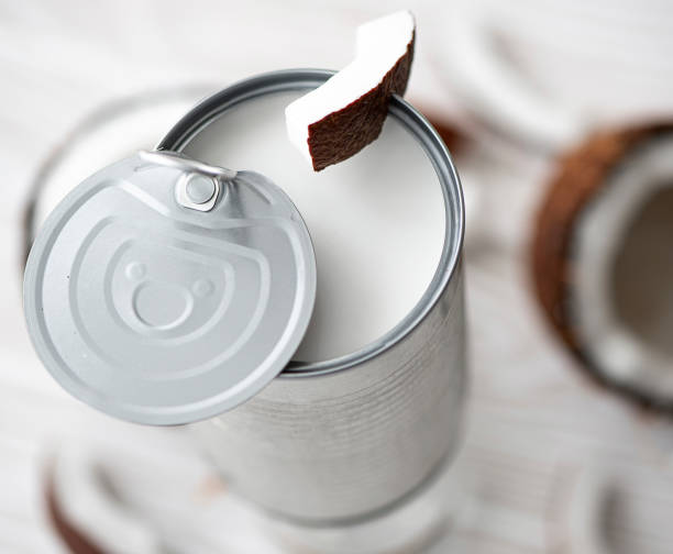 coconut milk in an open can coconut milk in an open can with coconut coconut milk stock pictures, royalty-free photos & images