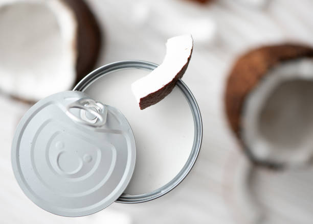coconut milk in an open can coconut milk in an open can with coconut coconut milk stock pictures, royalty-free photos & images