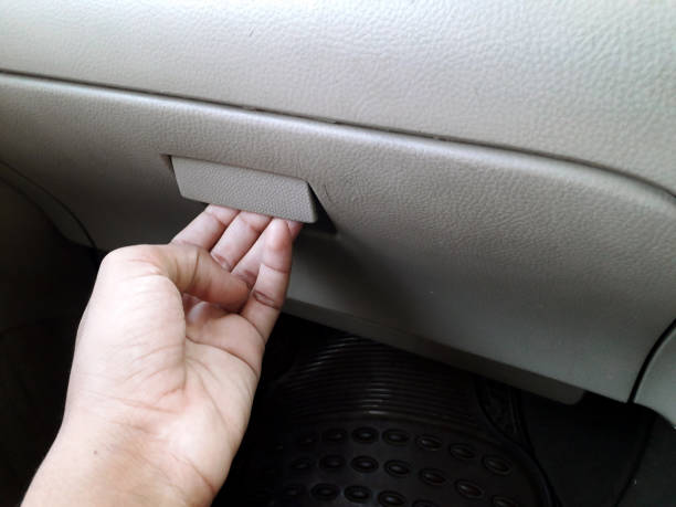 Asian female opening glove compartment or document box in a car A person opening the glove compartment or document box of car glove box stock pictures, royalty-free photos & images