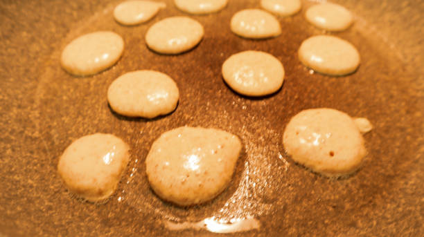 istock raw dutch mini pancakes cooking in the pan 1227563552