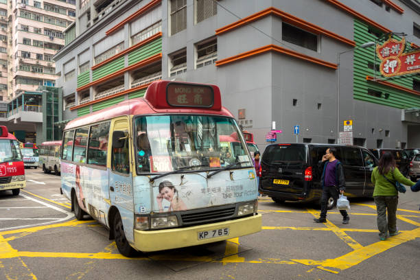 Mongkok / Hong Kong - January 2018 : Minibus is stopping for pedestrian crossing the street in rush hour, very busy. This moment is seem to be normal in Hong Kong street.