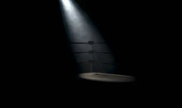 A dramatic closeup of a dimly spotlit corner of a vintage boxing ring surrounded by ropes on a dark isolated background - 3D render