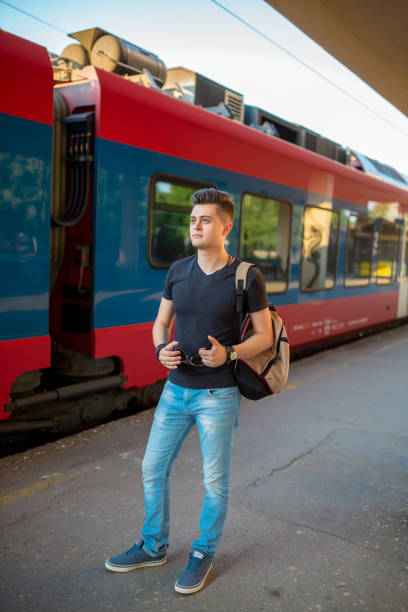 istock Man standing on the subway platform, waiting for his train. 1227569700