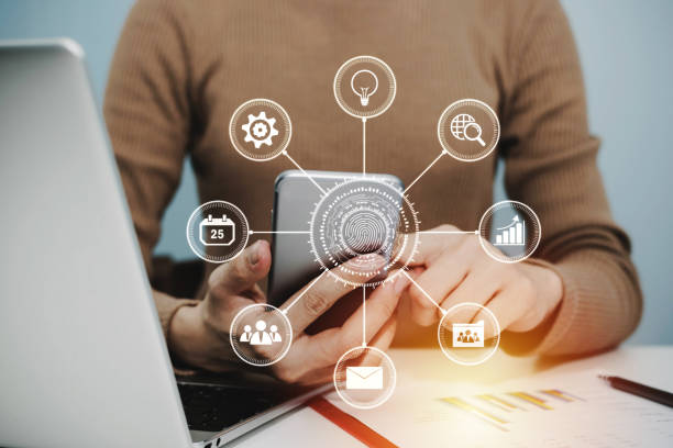 istock 5G. woman hand using digital mobile phone with virtual graphic icon, laptop computer and report on desk at home office, digital marketing, work from home, business finance, network technology concept 1227570929