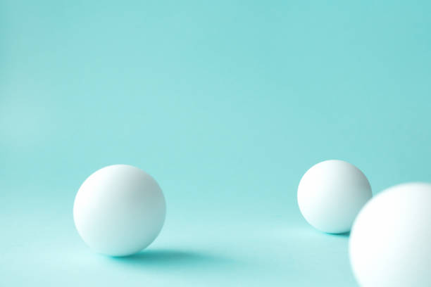 istock White ping pong balls on mint green background with selective focus, some defocused. Abstract backgrounds with geometric sphere shapes and copy space for text on top 1227571049