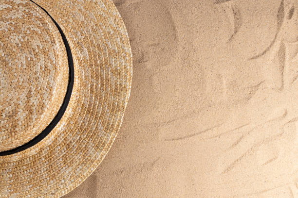 istock Summer vacation composition. Hat on sand background with a copy of space. Summer background 1227571217