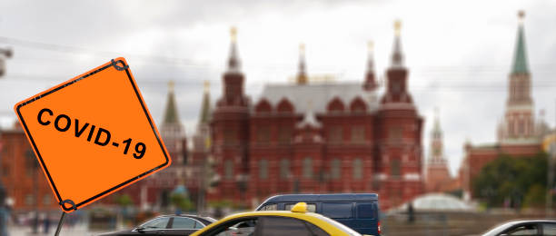 Coronavirus Road Warning Sign in front of Kremlin, Moscow, Russia.