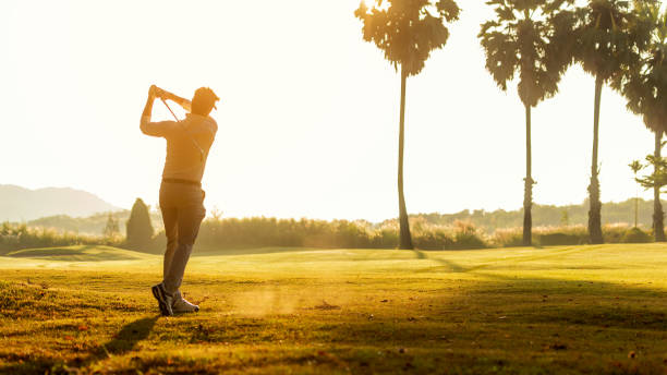 golfer sport course golf ball fairway.  people lifestyle man playing game golf tee of on the green grass.  asian man player game shot in summer, sunlight background.  healthy and sport outdoor - golf golf course sunrise morning imagens e fotografias de stock