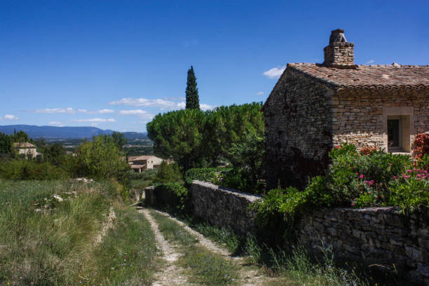 Lacoste, France - June 23, 2024: Tile rooftop of stone homes in the tiny village in Provence