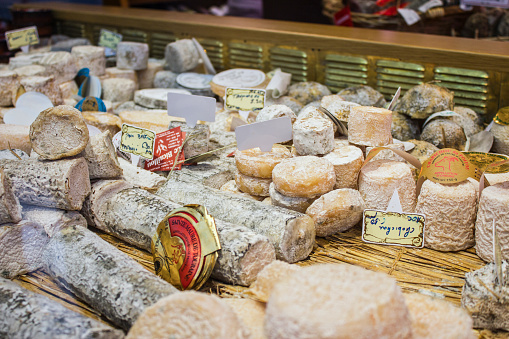 Paris - Circa May 2011: French Cheese Shop with a selection of Camembert, Coulommiers, Munster, Gruyere, Comte, and Parmesan cheeses.