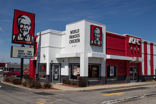 Indianapolis - Circa April 2020: KFC Chicken restaurant. Kentucky Fried Chicken is offering Uber and Door Dash delivery and drive thru service during social distancing.