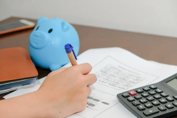 istock Financial data analyzing hand writing and counting on calculator at home on wooden desk,Business and finance concept. 1227575191