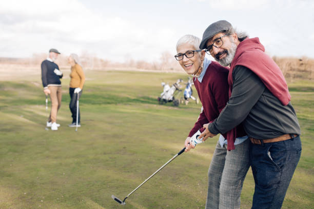 istock Senior woman learning playing golf with her husband 1227575408
