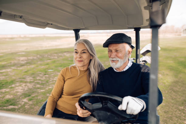 istock Senior couple enjoying in a golf cart before playing golf 1227575544