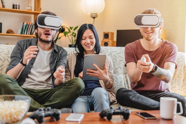istock Happy friends having fun with VR googles at home interior 1227577317