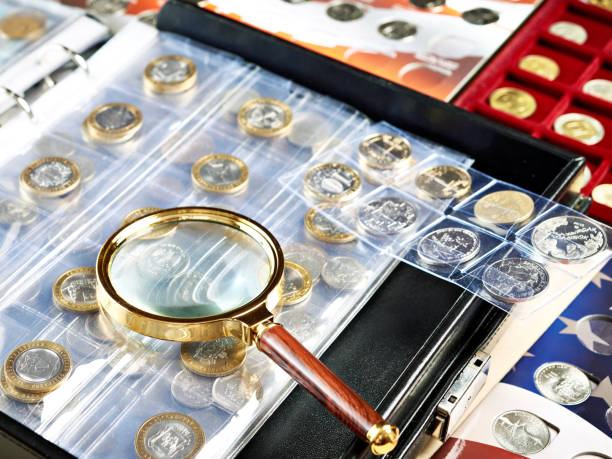 istock Numismatic coins with magnifying glass 1227577941