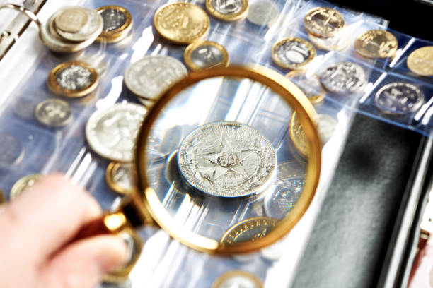 istock Old numismatics silver coins with magnifying glass 1227578754