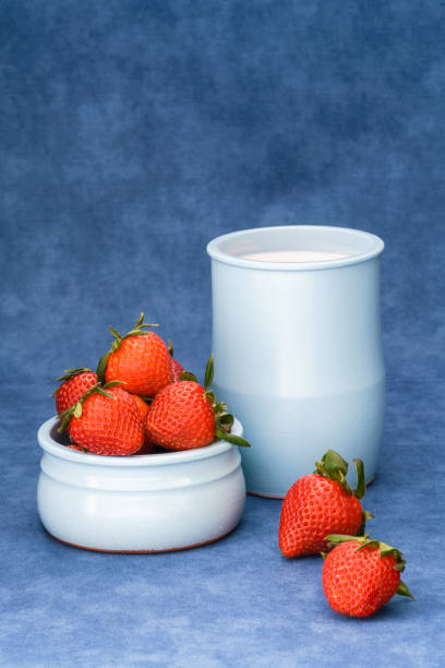 Delicious fresh strawberries in a bowl with yogurt stock photo