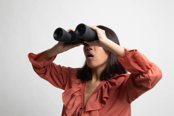 istock Young Asian woman with binoculars . 1227582718