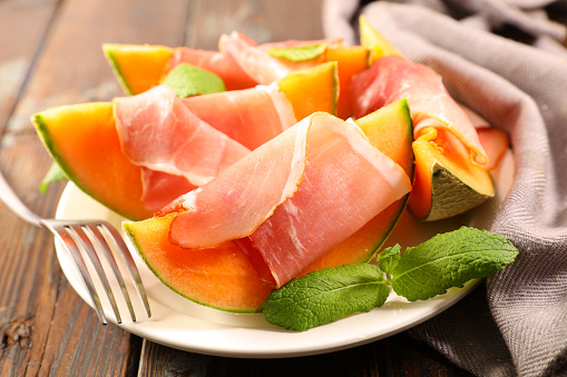 melon sliced with prosciutto ham and basil