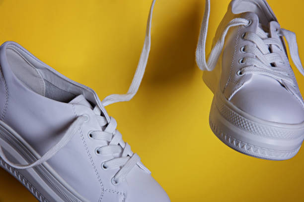 istock Flying in the air white sneakers. 1227584574