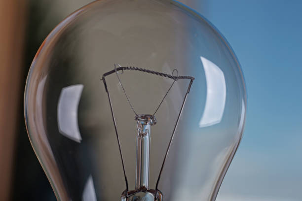 istock Light bulb on a background of blue sky. 1227584577