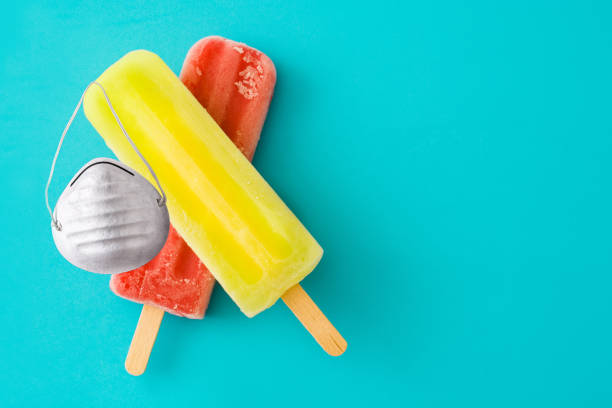 istock Lemon and strawberry popsicles with protective face mask 1227586461