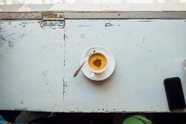 An aerial shot of a cup of coffee on a restaurant counter in Bali.