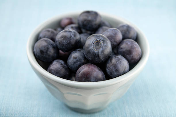 Blueberries in bowl on blue napkin