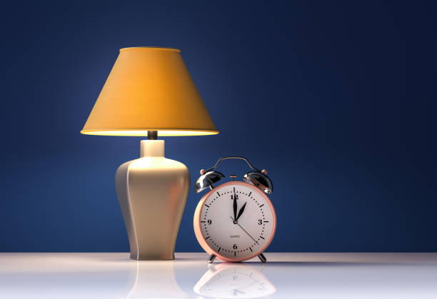 istock Yellow lamp and alarm clock on blue background - interior - 3d rendering 1227587650
