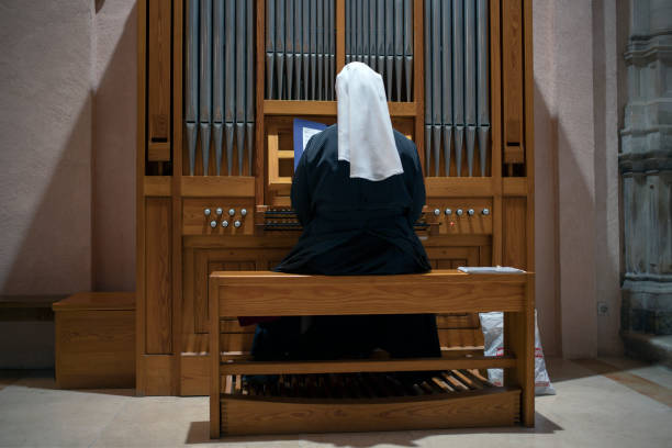 Montenegro - Nun playing acoustic organ into the Cathedral of Saint Tryphon (Sveti Tripun) in Kotor stock photo