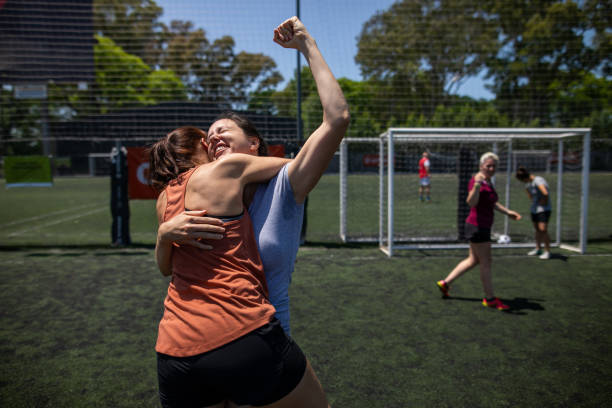 istock Teammates celebrating winning a match on soccer field 1227588534