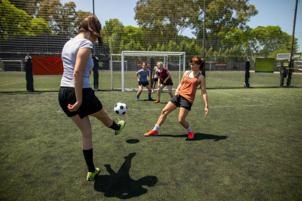 istock Female soccer player shooting at goal during friendly match 1227588597