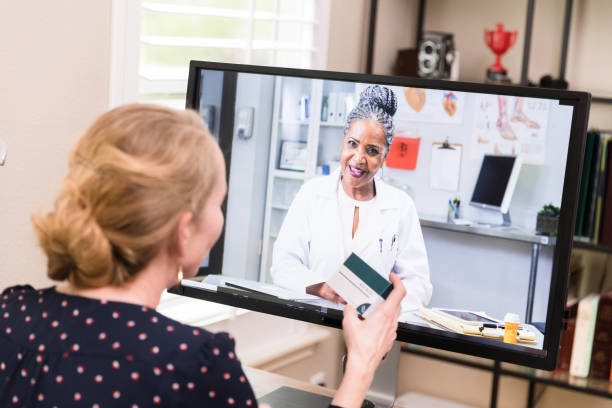 istock Woman video conferences with pharmacist about medication 1227588599