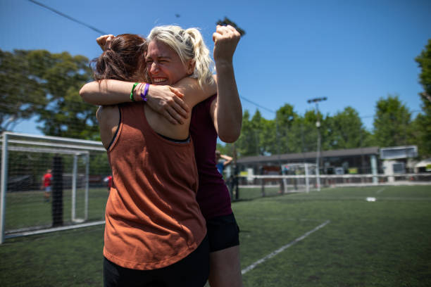 istock Teammates celebrating winning a match on soccer field 1227589152