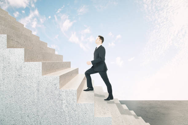 istock Young businessman climbing abstract stairs 1227589799