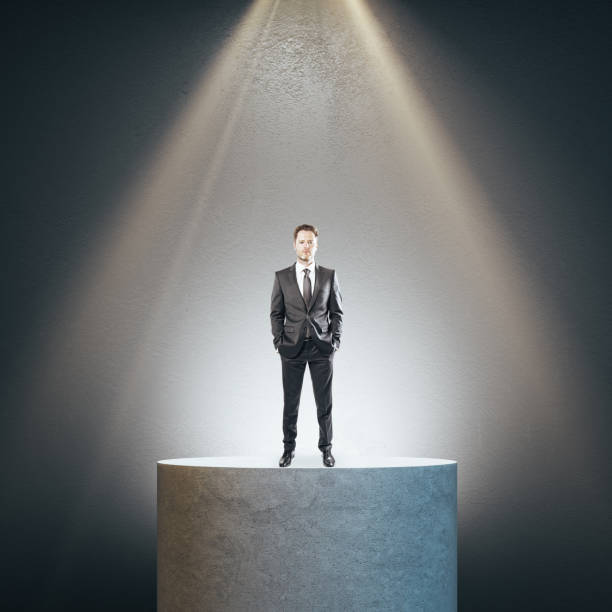 istock Businessman standing on concrete pedestal 1227590149