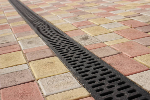 istock Rainwater drainage system on a sidewalk of colored tiles diagonal 1227590369
