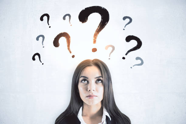 istock Thinking businesswoman with question marks 1227591365