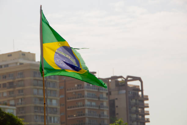 istock brazil flag outdoors with buildings in the background 1227591678