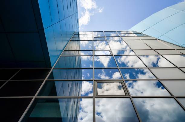 istock reflection of blue sky with clouds in an office building window 1227591718
